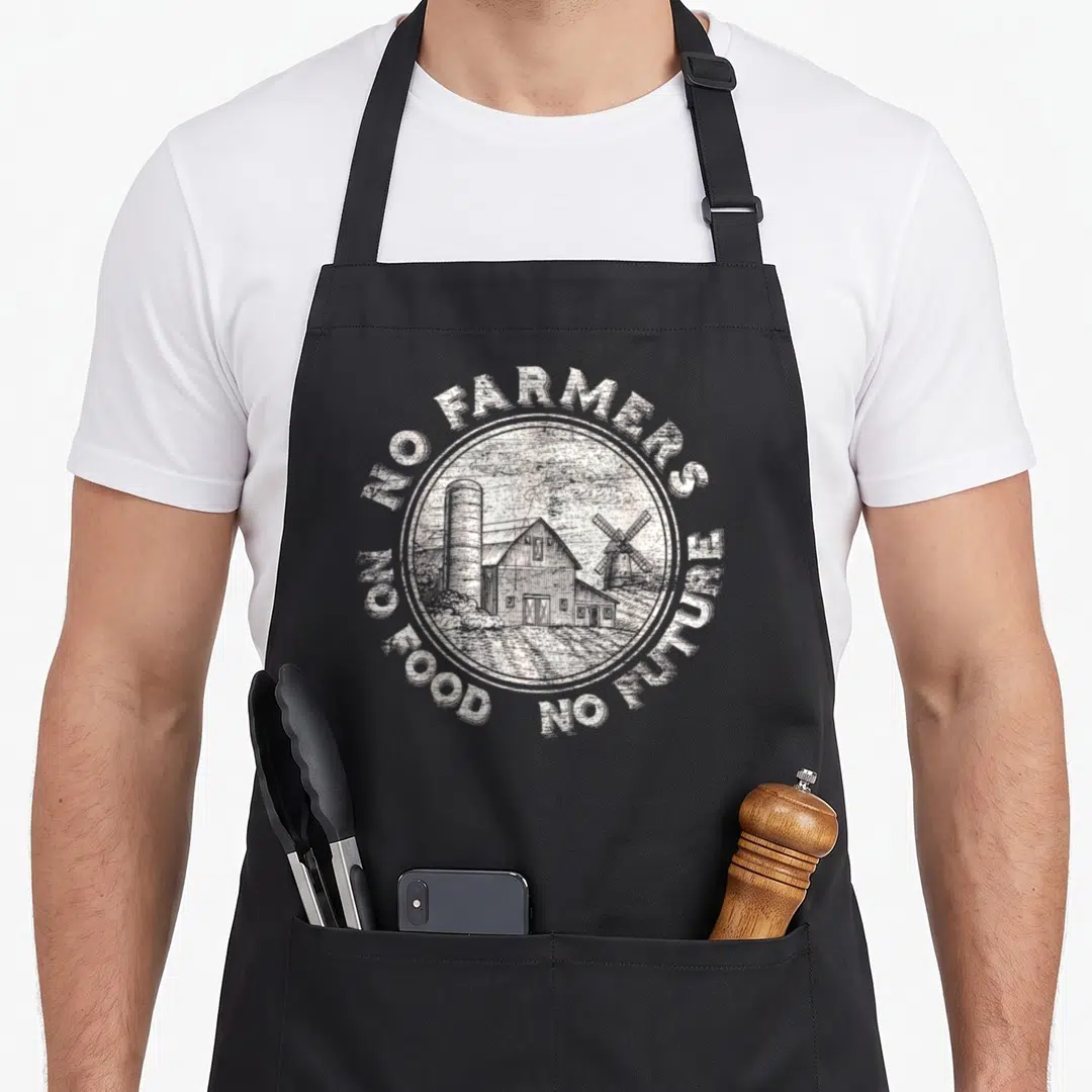 Food farmer apron - White distressed circular farm scene with barn silo windmill and surrounding text No Farmers No — shown on a black cotton canvas apron against a white background