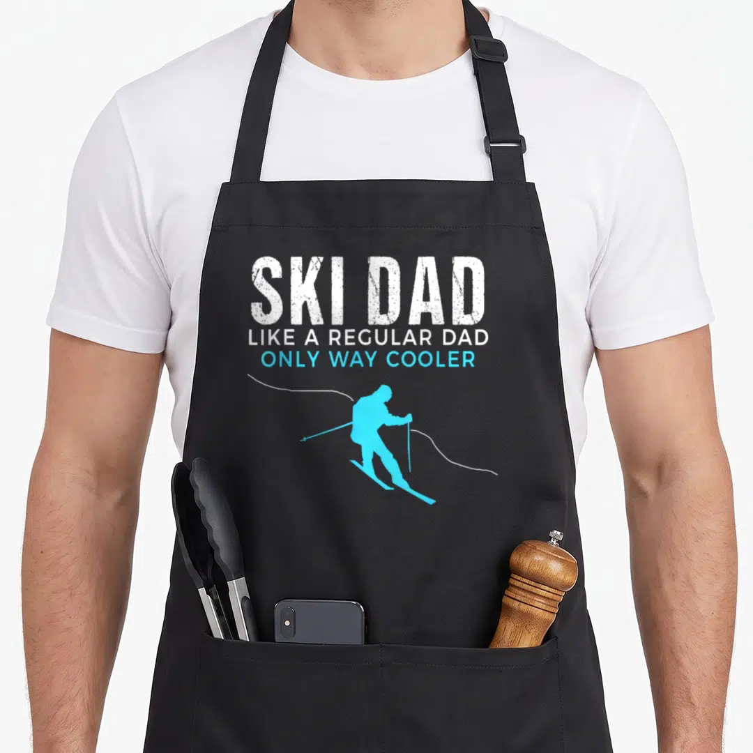 Skier ski apron - Skier Dad text with blue skier silhouette and wavy line — shown on a black cotton canvas apron against a white background
