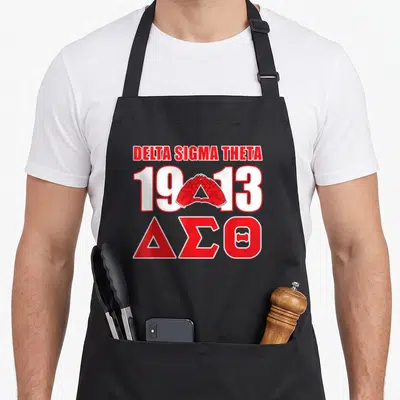 Sigma theta paraphernalia hbcu sorority apron - Red and white hands forming triangle between 1913 numbers with Delta — shown on a black cotton canvas apron against a white background