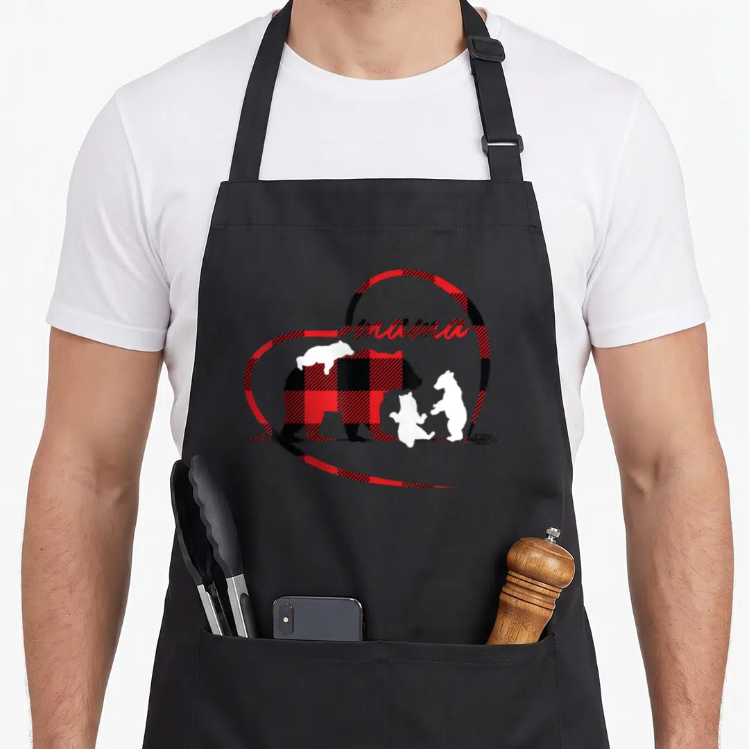 Buffalo red plaid apron - Cartoon bear and cubs in red black plaid heart with mama text and arrow — shown on a black cotton canvas apron against a white background