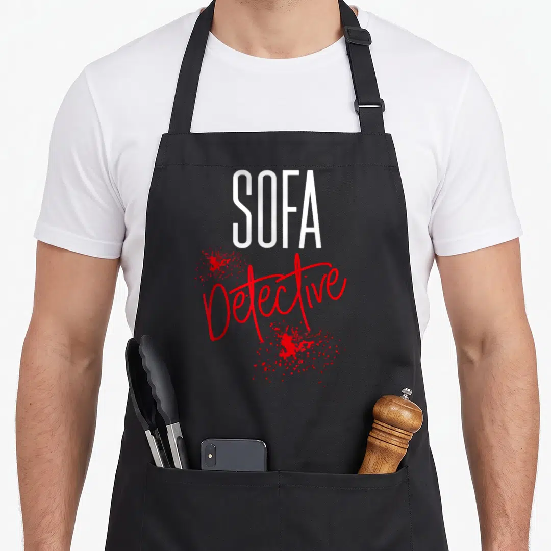 Sofa basically yours apron - Stacked white SOFA and red cursive Detective text with red splatters — shown on a black cotton canvas apron against a white background