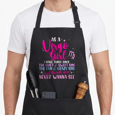 Virgo a's aprons - Stacked pink white and blue text reading As A Virgo Girl I Have Three Sides with small stars — shown on a black cotton canvas apron against a white background