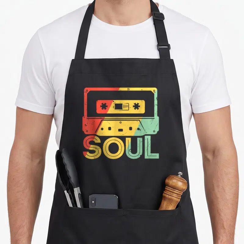 Funk costume 70s apron - Retro cassette tape and SOUL text with red yellow green vertical split — shown on a black cotton canvas apron against a white background