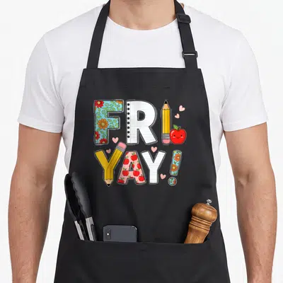 Weekend school teacher apron - Cartoon FRIDAY YAY text with pencils apples floral patterns and pink hearts — shown on a black cotton canvas apron against a white background