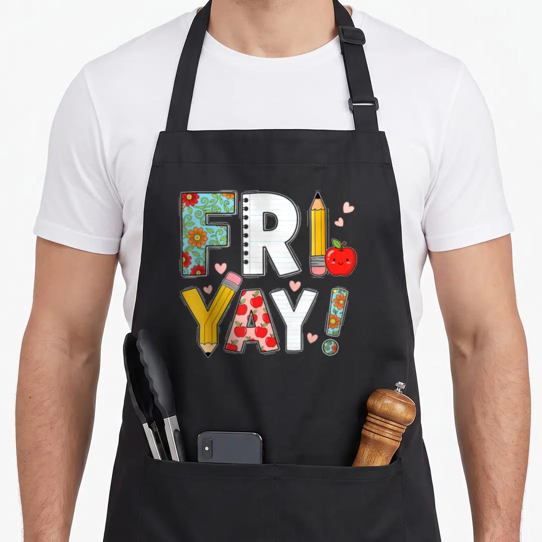 Weekend school teacher apron - Cartoon FRIDAY YAY text with pencils apples floral patterns and pink hearts — shown on a black cotton canvas apron against a white background