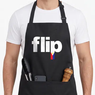 Pinoy pride apron - White text flip with Philippine flag replacing the letter i stem in red blue and yellow — shown on a black cotton canvas apron against a white background