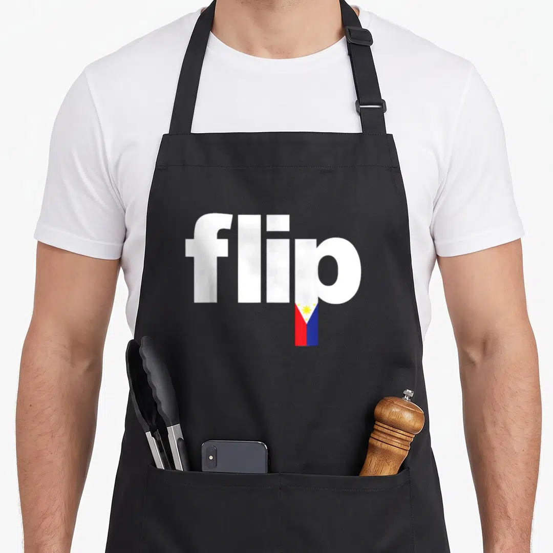Pinoy pride apron - White text flip with Philippine flag replacing the letter i stem in red blue and yellow — shown on a black cotton canvas apron against a white background