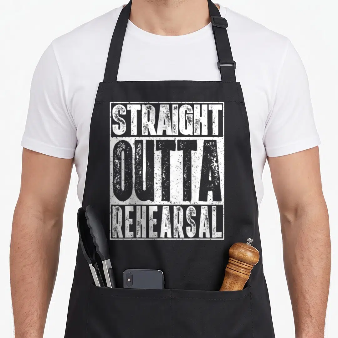 Straight actor apron - White stacked text reading STRAIGHT OUTTA REHEARSAL inside a rectangular border — shown on a black cotton canvas apron against a white background
