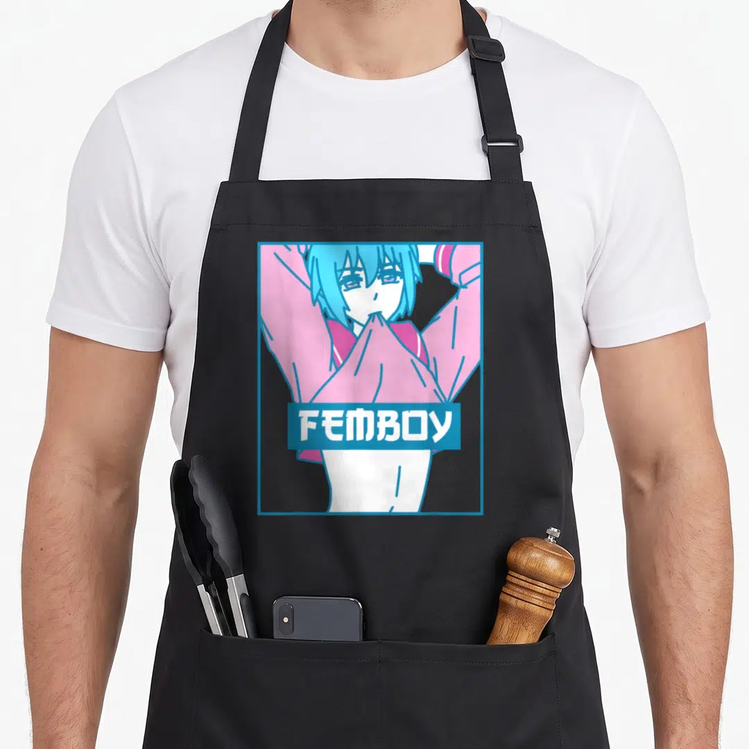 Femboy anime cooking apron - Cartoon person lifting pink shirt inside blue frame with FEMBOY text in blue rectangle — shown on a black cotton canvas apron against a white background