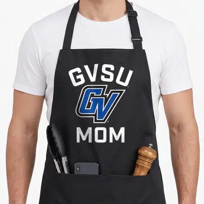 Valley lakers apron - GVSU arched text, blue GV logo, and MOM text in white and black — shown on a black cotton canvas apron against a white background
