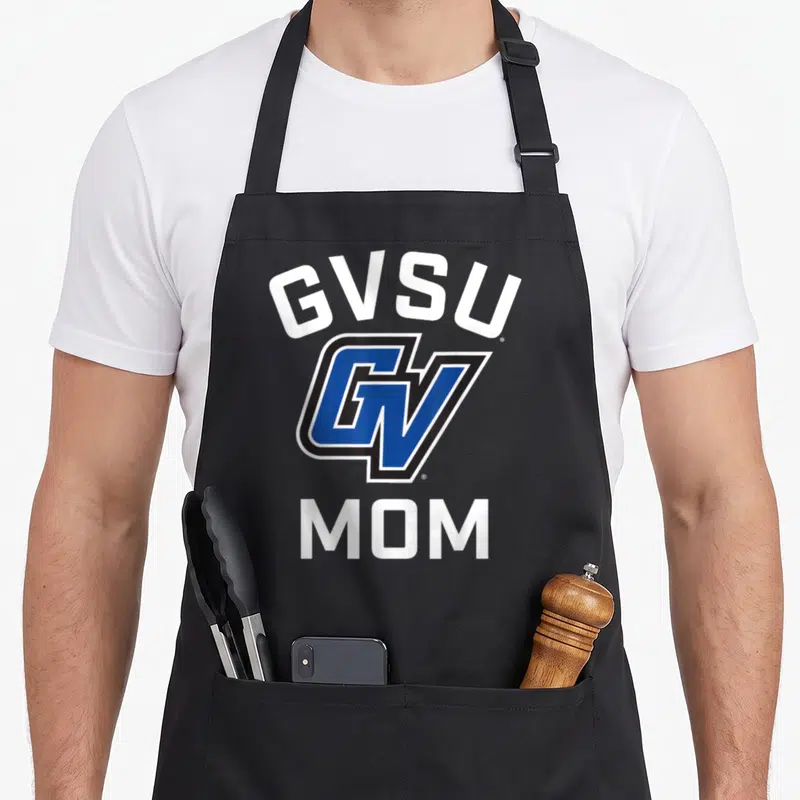 Valley lakers apron - GVSU arched text, blue GV logo, and MOM text in white and black — shown on a black cotton canvas apron against a white background