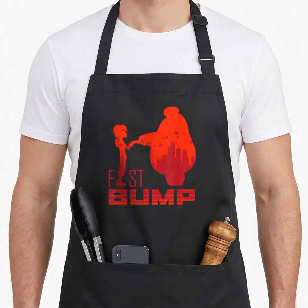 Hero friends apron - Two red silhouettes fist bumping with city skyline details inside shapes — shown on a black cotton canvas apron against a white background