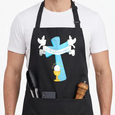 Grandson communion aprons - Blue cross with white banner reading My First Communion, two white doves, and gold chalice — shown on a black cotton canvas apron against a white background