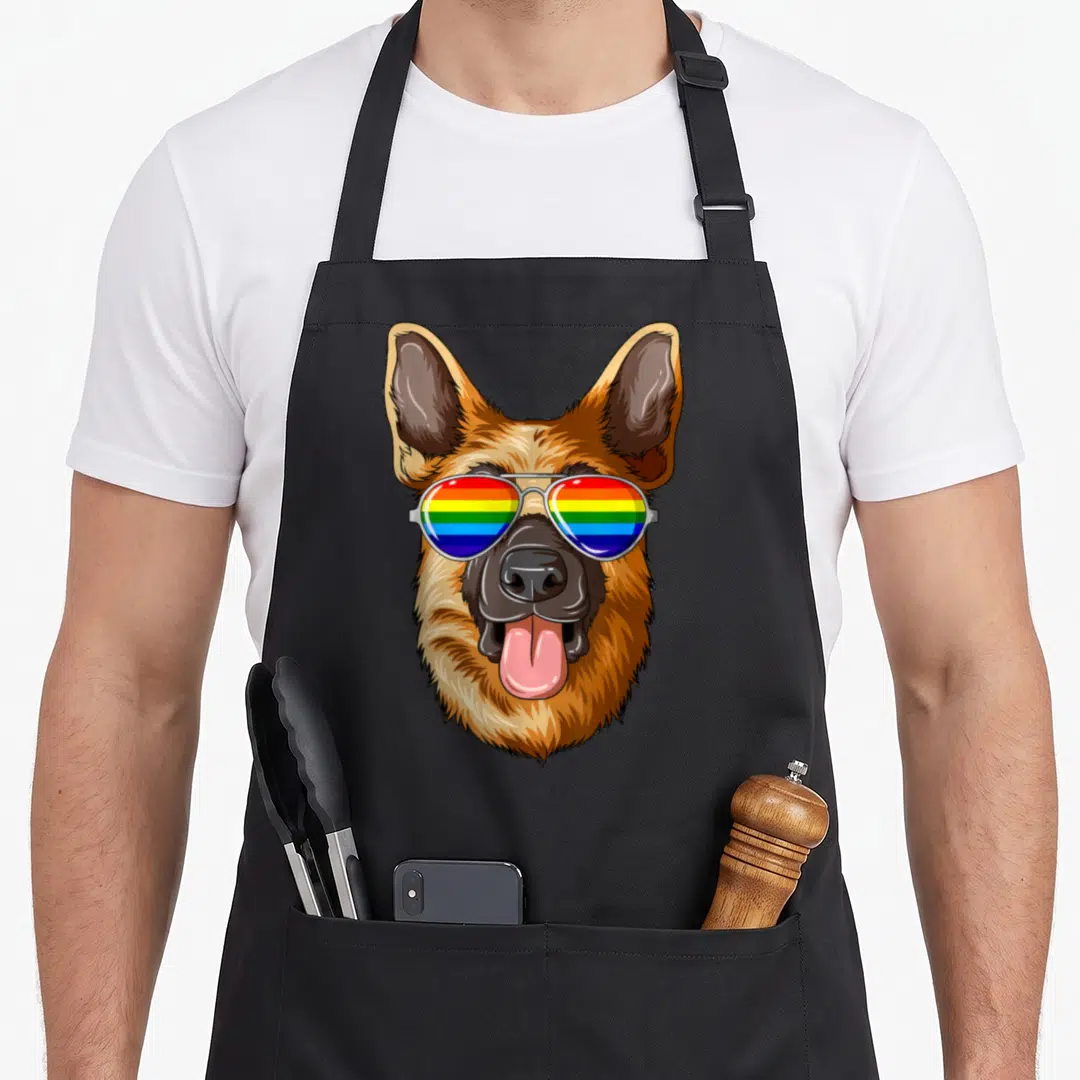 Shepherd flag gay pride apron - Cartoon German Shepherd head wearing aviator sunglasses with rainbow lenses — shown on a black cotton canvas apron against a white background