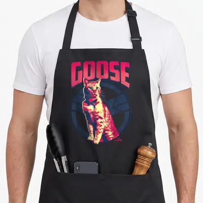 Tonal goose apron - Red and yellow cartoon cat sitting in front of blue circle under red GOOSE text — shown on a black cotton canvas apron against a white background