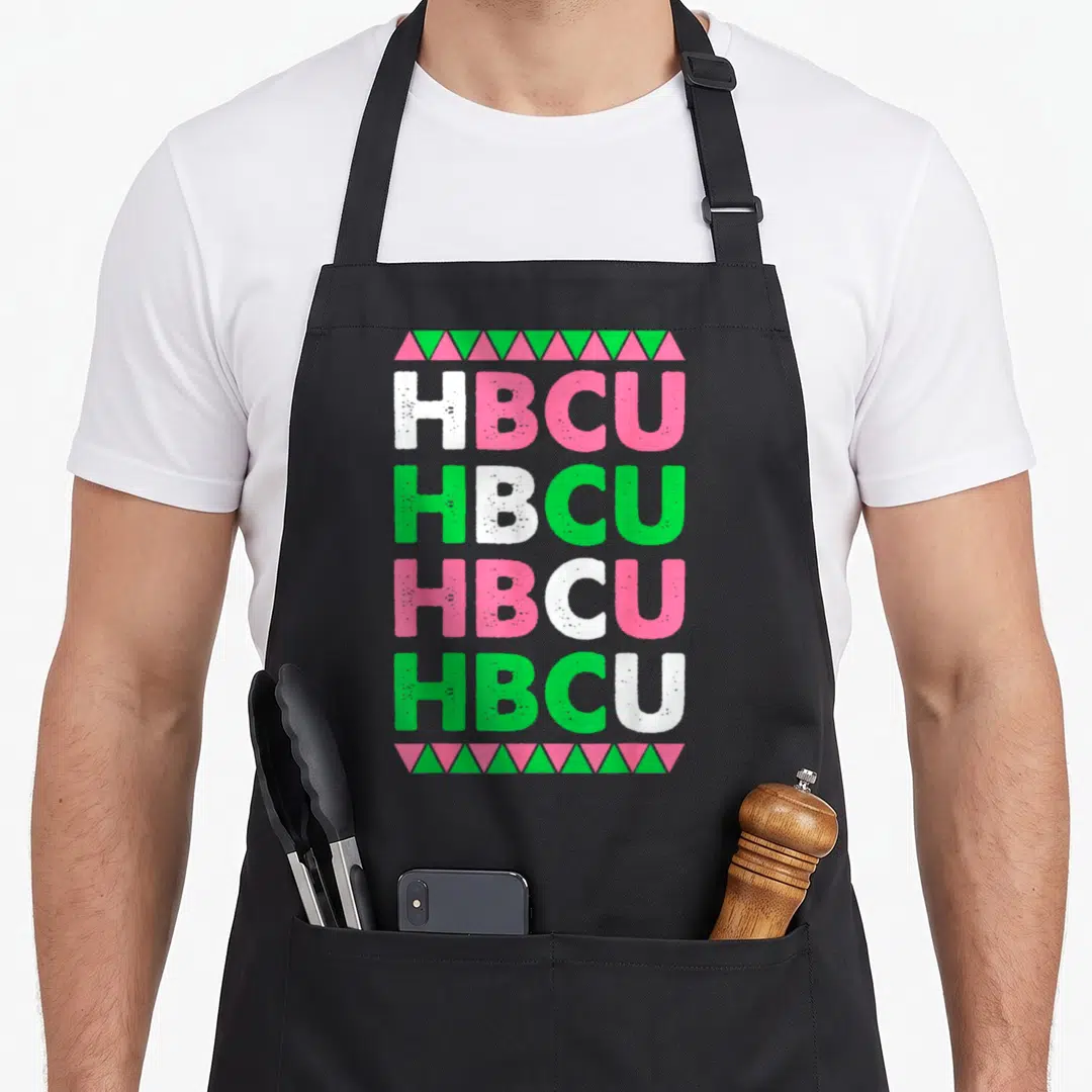 Hbcu best college ever apron - Stacked HBCU text in pink green white with triangle borders — shown on a black cotton canvas apron against a white background