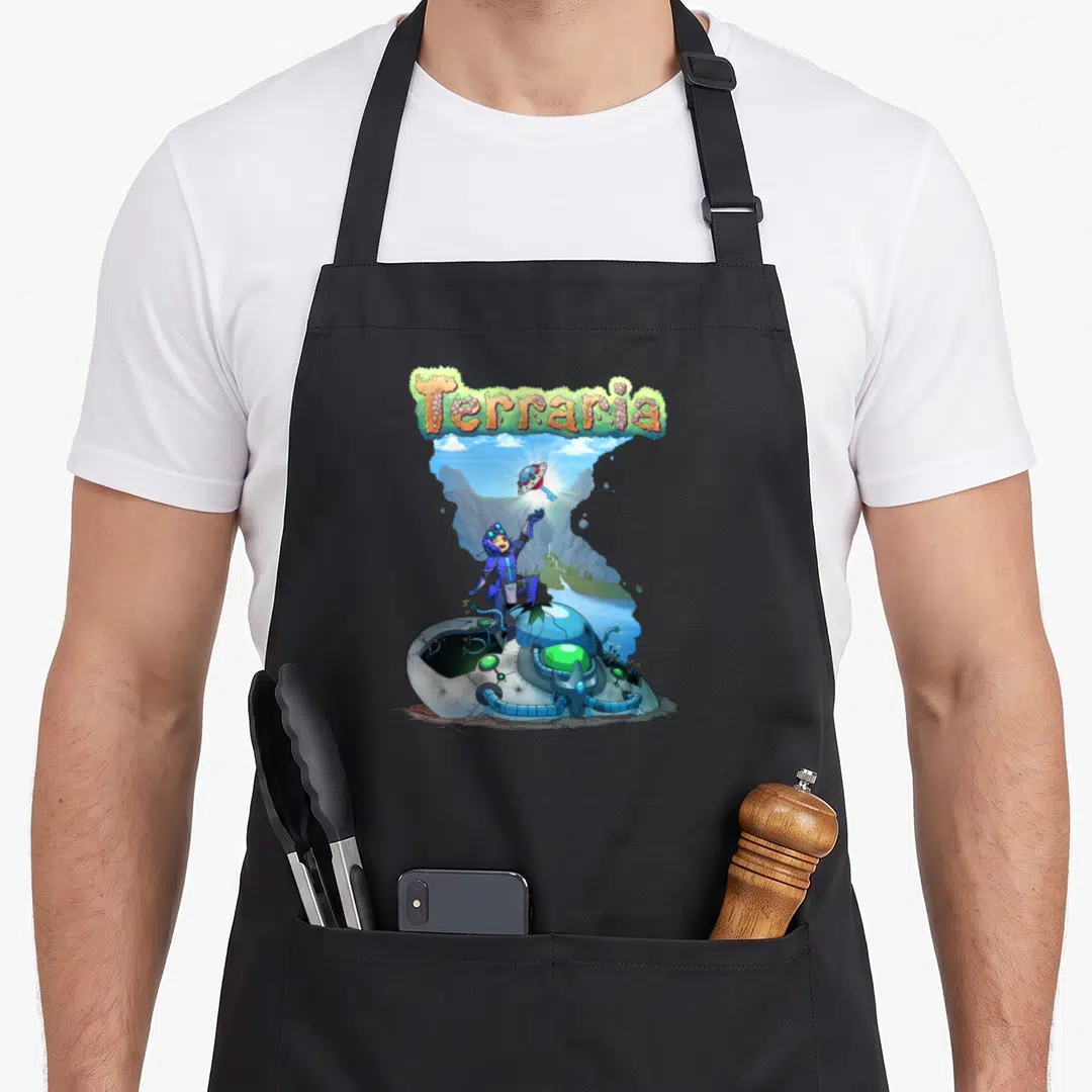 Terraria car apron - Character on crashed spaceship reaching for glowing UFO key under arched Terraria logo — shown on a black cotton canvas apron against a white background