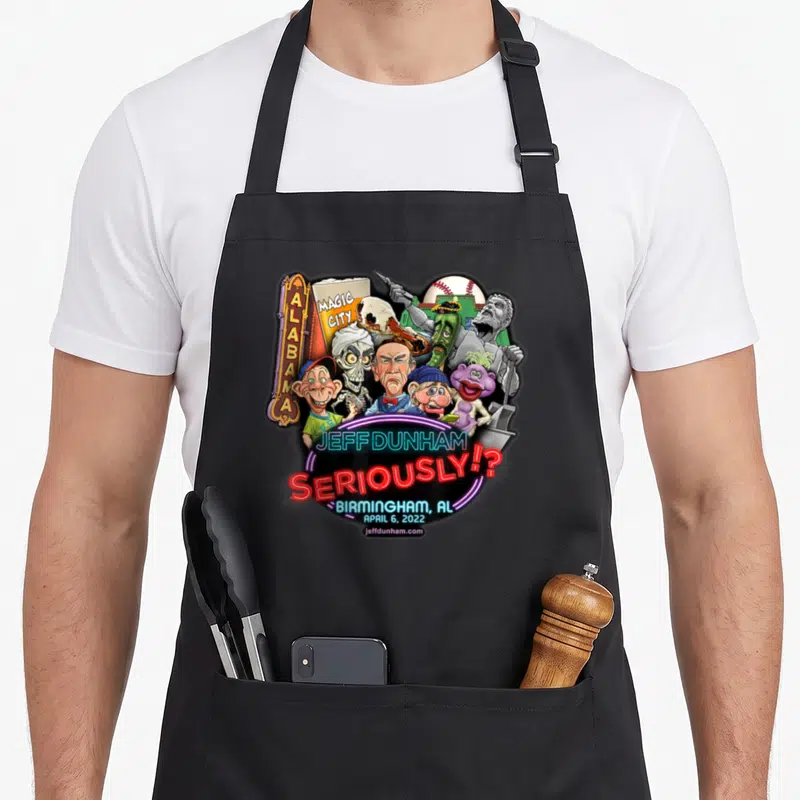 Jeff birmingham apron - Neon Jeff Dunham caricatures with Magic City sign and Birmingham date text — shown on a black cotton canvas apron against a white background