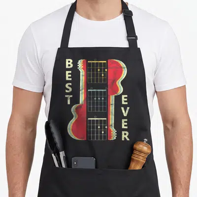 Band music dad apron - Retro red guitar with vertical BEST EVER text and three fretboard chord diagrams — shown on a black cotton canvas apron against a white background