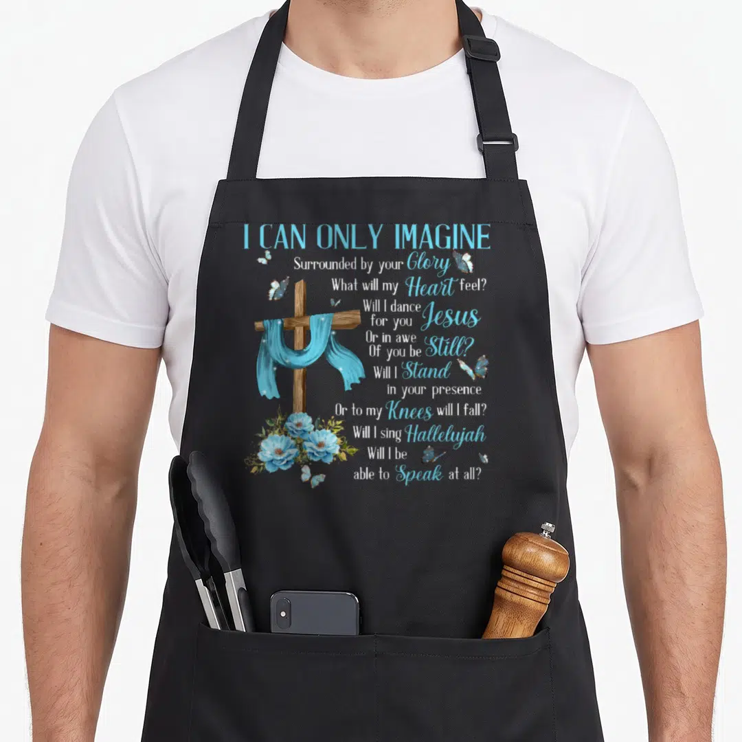 Imagine christian aprons - Wooden cross with blue cloth, stacked lyrics, blue flowers, and butterflies — shown on a black cotton canvas apron against a white background