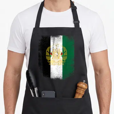 Panjshir afghanistan apron - Distressed flag with three vertical stripes and gold emblem on white background — shown on a black cotton canvas apron against a white background