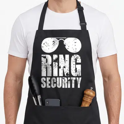Security funny wedding aprons - White distressed sunglasses above stacked RING SECURITY text — shown on a black cotton canvas apron against a white background