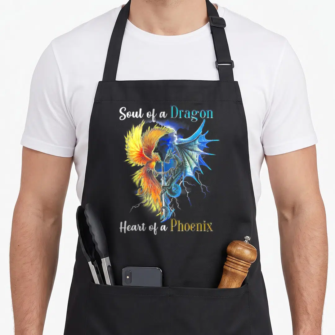 Soul dragon apron - Watercolor phoenix and dragon facing vertical sword with Soul of a Dragon Heart of a Phoenix text — shown on a black cotton canvas apron against a white background