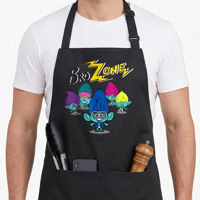 Troll spotlight apron - BroZONE text with yellow lightning bolt above five cartoon trolls with colorful hair — shown on a black cotton canvas apron against a white background