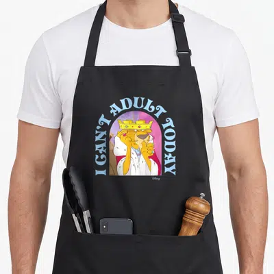 Prince crazy robin man apron - Cartoon lion in crown with I CAN'T ADULT TODAY text arch — shown on a black cotton canvas apron against a white background