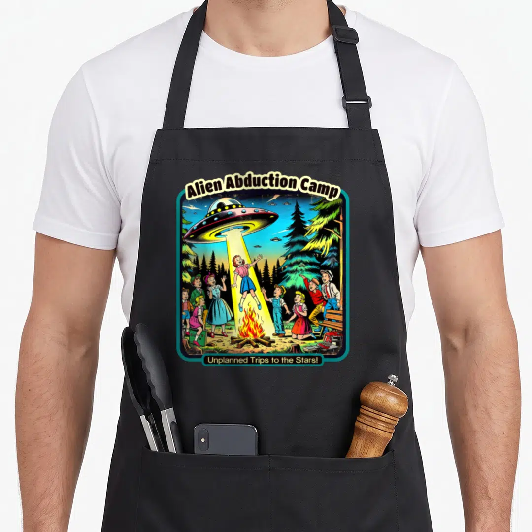 Abduction funny alien apron - Retro UFO beam lifts girl from campfire surrounded by children under Alien Abduction Camp — shown on a black cotton canvas apron against a white background