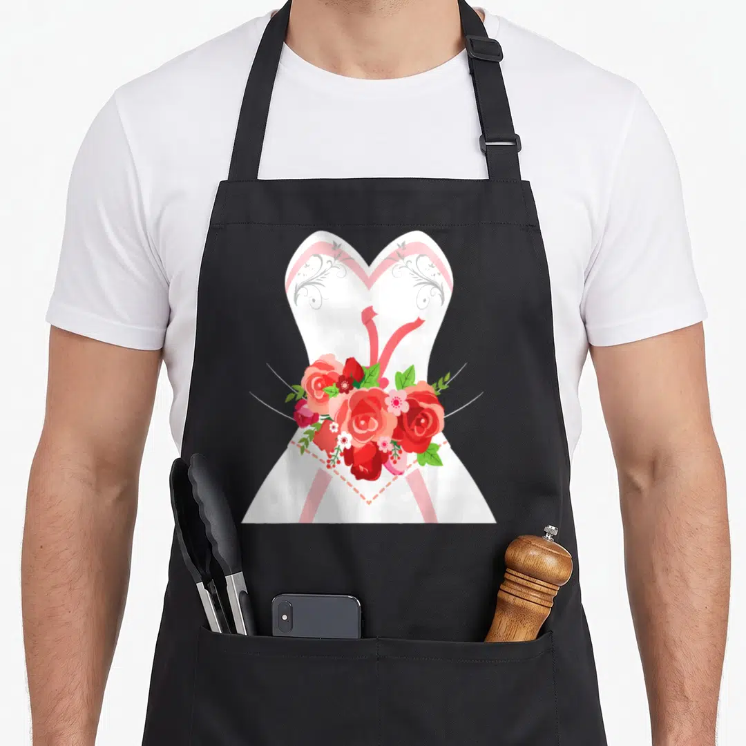 Simple bridal apron - White dress silhouette with grey swirls, red ribbon, and cluster of red and pink roses with green — shown on a black cotton canvas apron against a white background