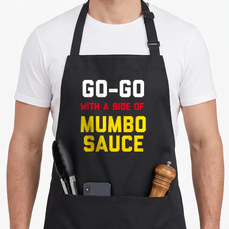 Music washington dc apron - Stacked text GO-GO WITH A SIDE OF MUMBO SAUCE in white red and yellow block letters — shown on a black cotton canvas apron against a white background