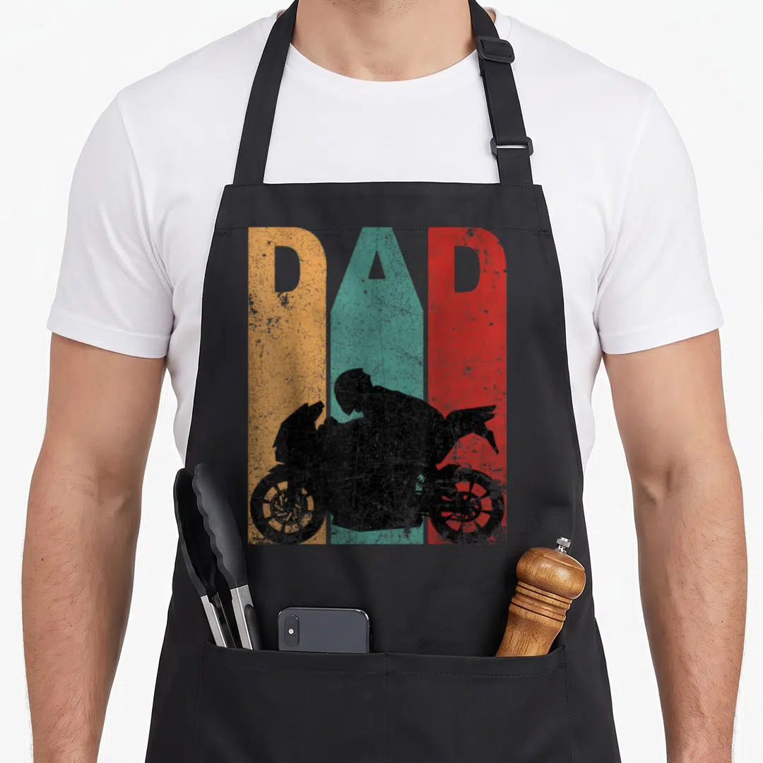 Sport bike apron - DAD cutout over orange teal red stripes with black motorcyclist silhouette — shown on a black cotton canvas apron against a white background