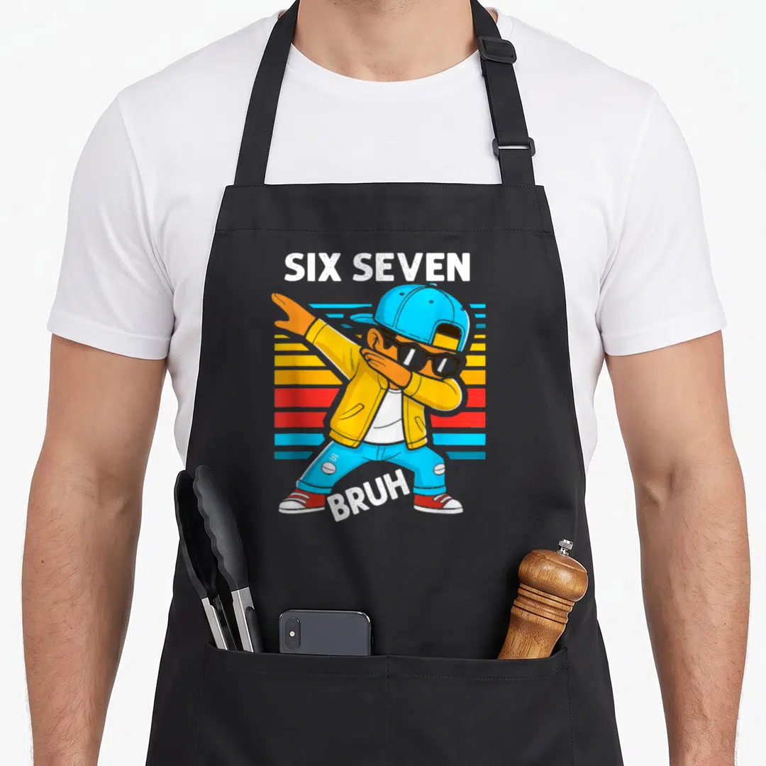 Bruh dabbing meme apron - Dabbing cartoon character with SIX SEVEN BRUH text over colored horizontal stripes — shown on a black cotton canvas apron against a white background