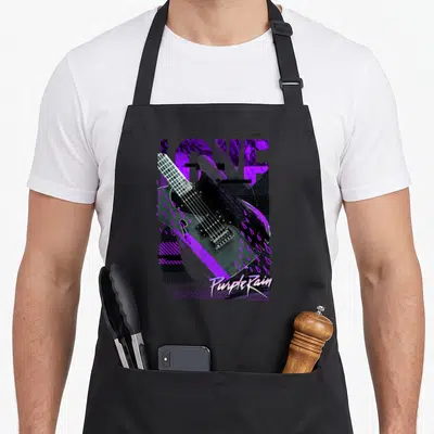 Wb100 birthday prince apron - Retro electric guitar with purple raindrops and LOVE text on black background — shown on a black cotton canvas apron against a white background