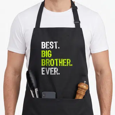 Brother stepbrother apron - Stacked white and lime green text reading BEST BIG BROTHER EVER on grey background — shown on a black cotton canvas apron against a white background