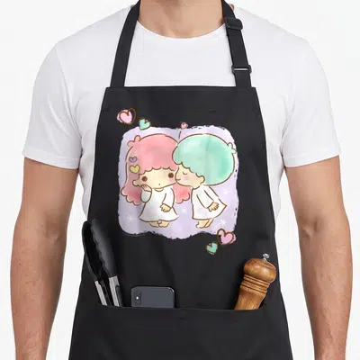 Star valentine apron - Two cartoon figures with pink and blue hair on purple cloud with hearts and stars — shown on a black cotton canvas apron against a white background