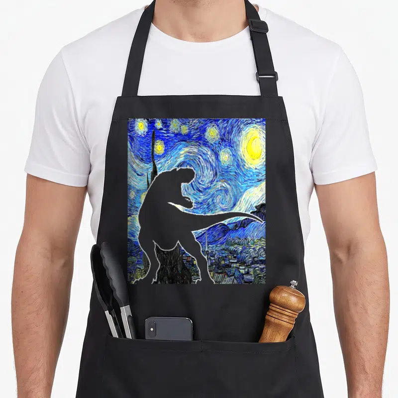 Dinosaur van gogh apron - Grey dinosaur silhouette over blue starry night painting with yellow stars — shown on a black cotton canvas apron against a white background