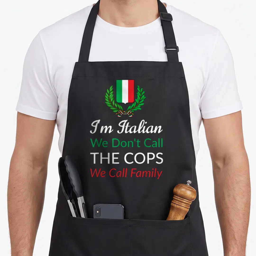 Call italy apron - Shield with green white red stripes and laurel wreath above four lines of text — shown on a black cotton canvas apron against a white background