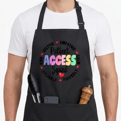 Squad patient apron - Patient Access Squad text with helpful empathic kind calm reliable friendly words and red hearts — shown on a black cotton canvas apron against a white background