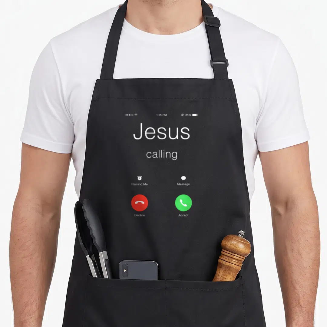Phone christian aprons - Smartphone screen showing Jesus calling with red decline and green accept buttons on grey — shown on a black cotton canvas apron against a white background