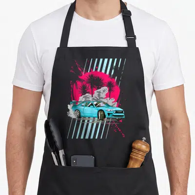 Retrowave car apron - Light blue drift car with smoke, pink sun, grey palm trees, and vertical stripes — shown on a black cotton canvas apron against a white background