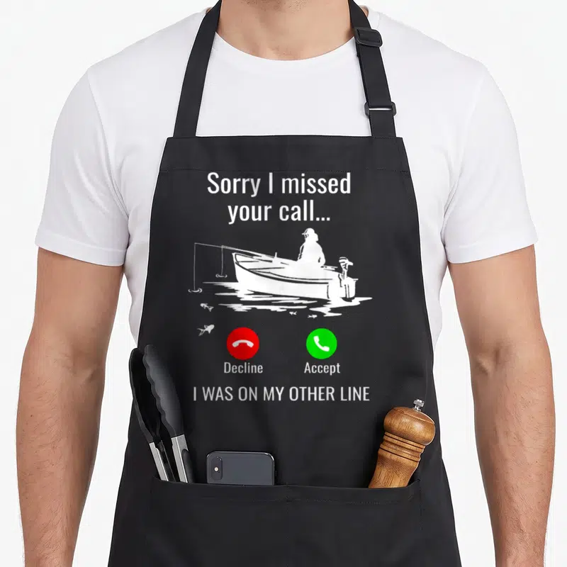 Call fishing aprons - Fisherman in boat with Sorry I missed your call text and red decline green accept buttons — shown on a black cotton canvas apron against a white background