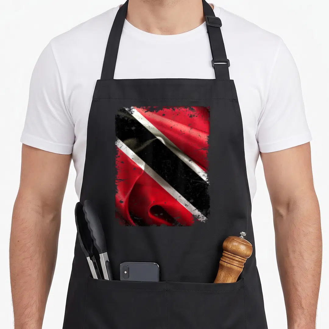 Trinidad trinidadian boy apron - Waving distressed flag in red black and white on black bib apron — shown on a black cotton canvas apron against a white background