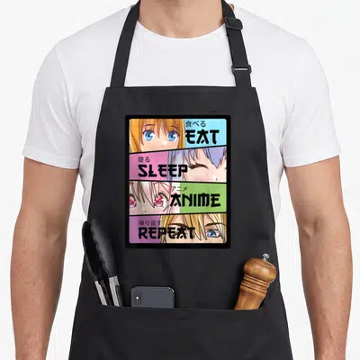 Eat kawaii cooking apron - Four-panel anime face grid with EAT SLEEP ANIME REPEAT text on blue pink green purple — shown on a black cotton canvas apron against a white background