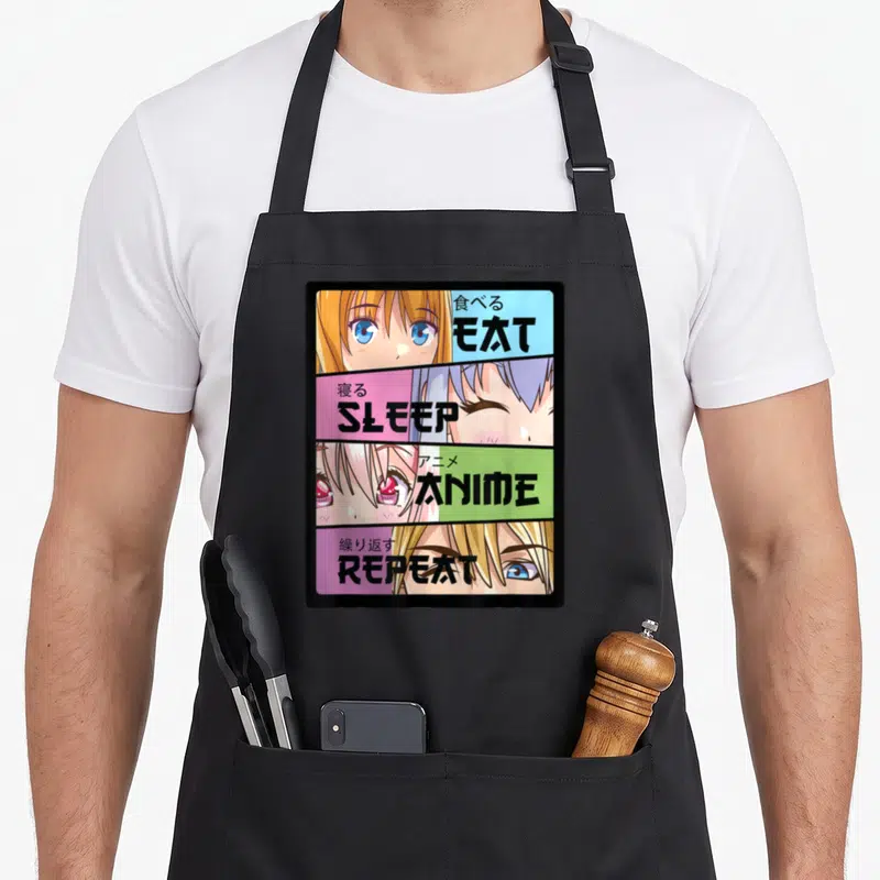 Eat kawaii cooking apron - Four-panel anime face grid with EAT SLEEP ANIME REPEAT text on blue pink green purple — shown on a black cotton canvas apron against a white background