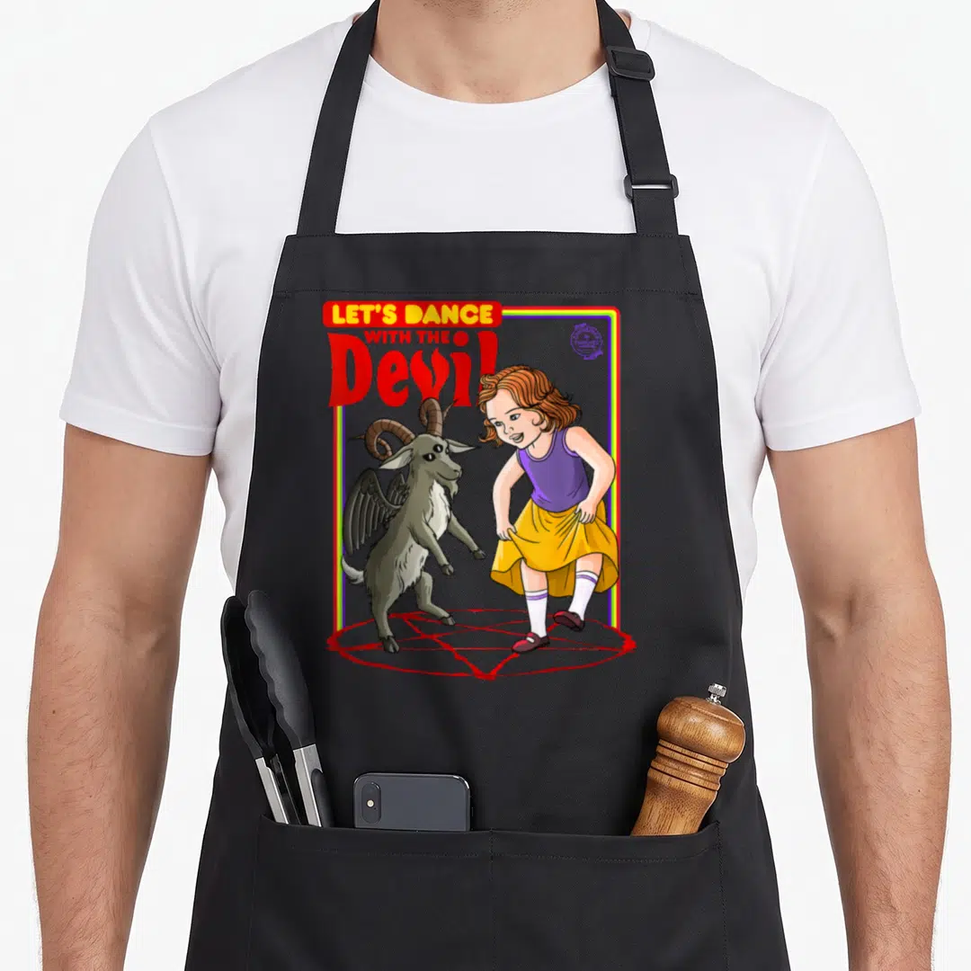 Dance devil's apron - Cartoon girl and horned goat dancing on red pentagram under LET'S DANCE WITH THE Devil text — shown on a black cotton canvas apron against a white background