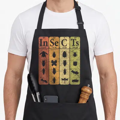 Insect table apron - Four colorful periodic table cells spelling Insects with grey insect silhouettes on a distressed — shown on a black cotton canvas apron against a white background