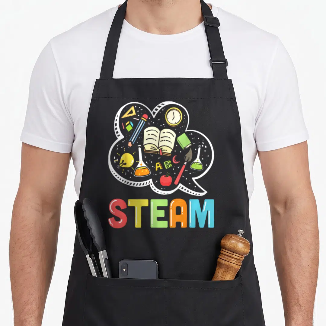 Steam student teacher apron - White cloud bubble with school supplies above colorful STEAM text — shown on a black cotton canvas apron against a white background