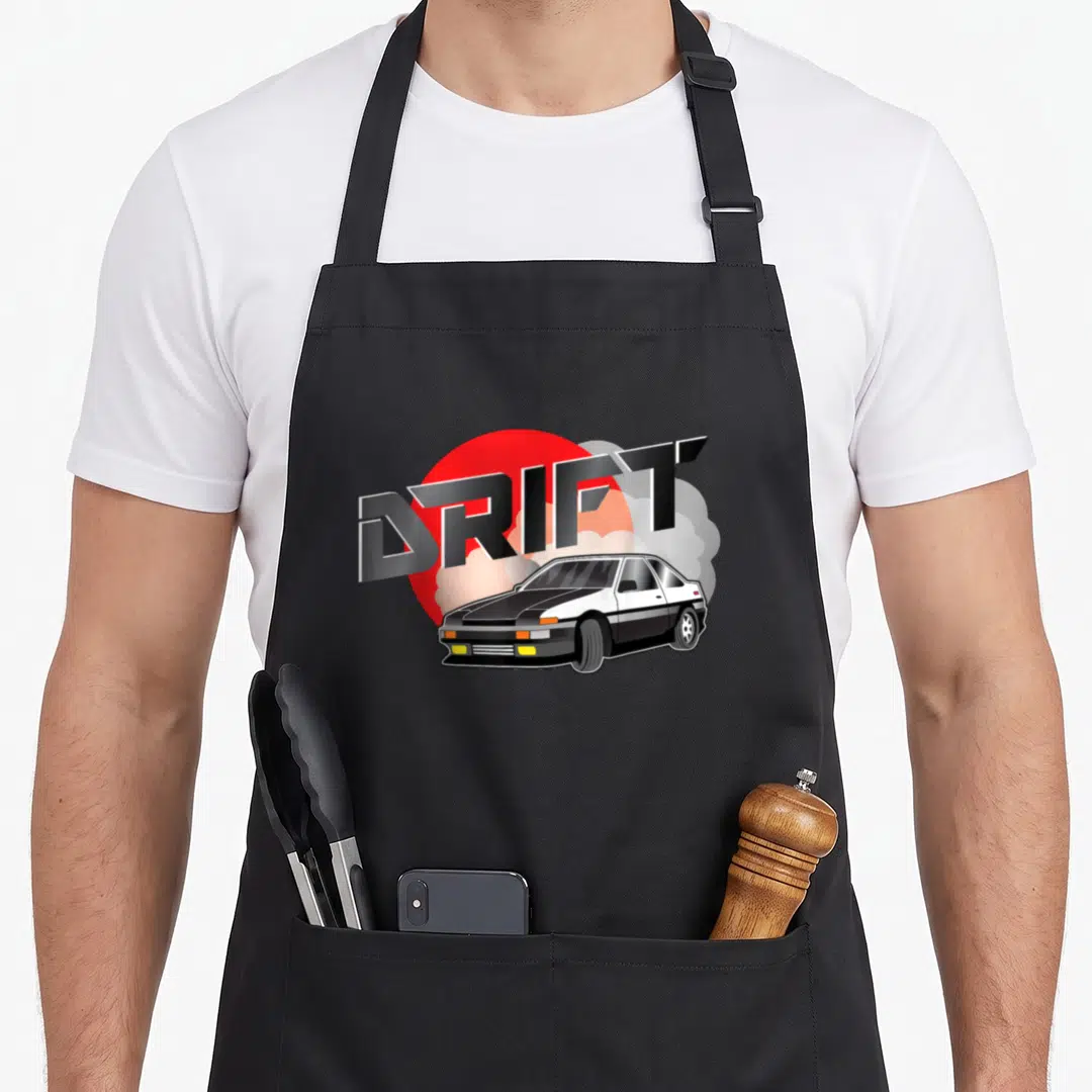 Touge car apron - DRIFT text over red circle and grey smoke with black and white cartoon car — shown on a black cotton canvas apron against a white background
